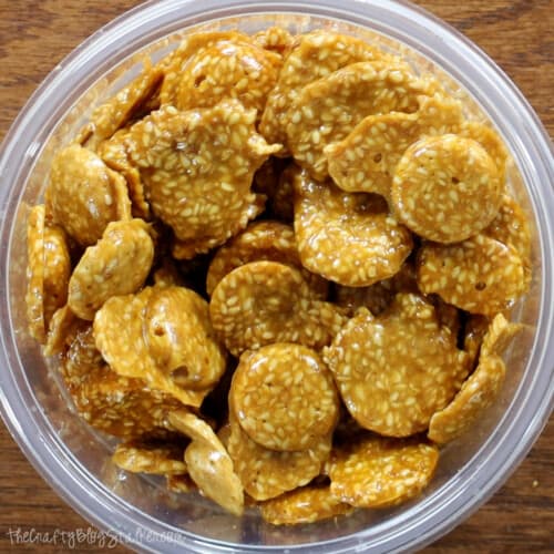 pieces of honey sesame seed candy in a round container