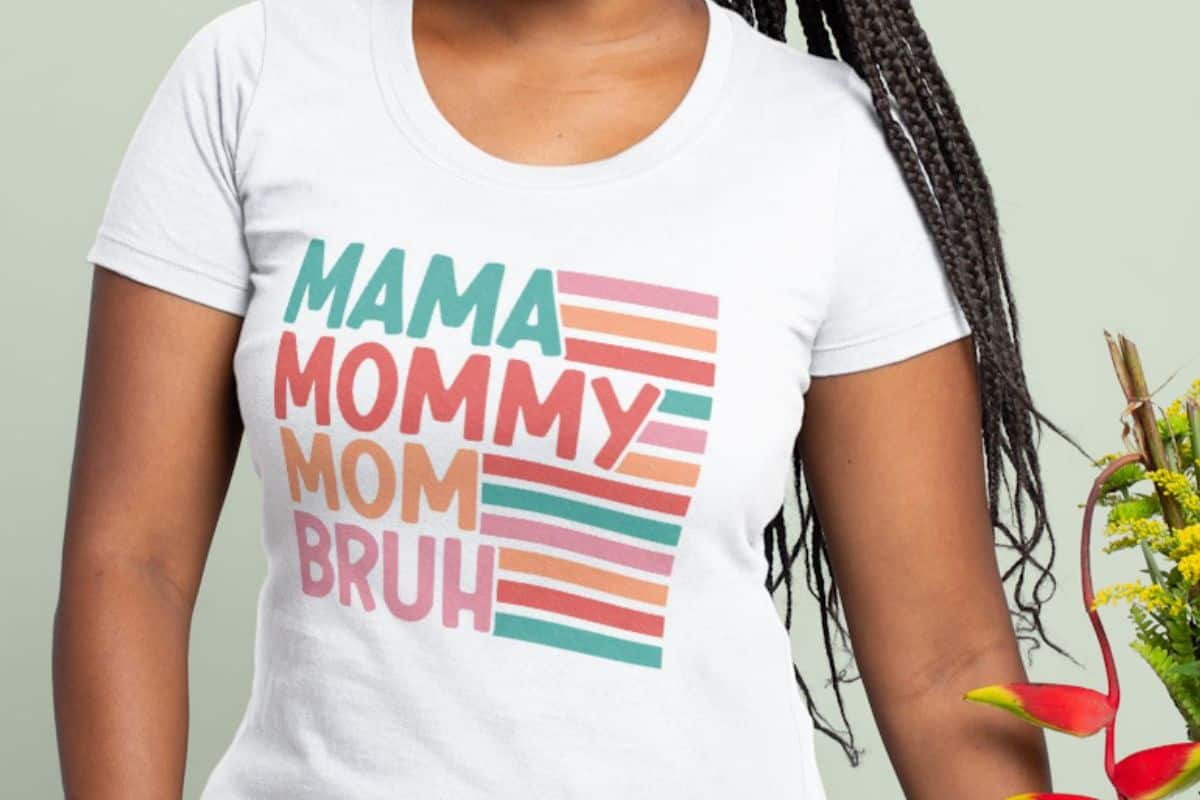 Woman wearing a shirt that reads Mama Mommy Mom Bruh.