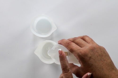 pouring resin into another silicone measuring cup