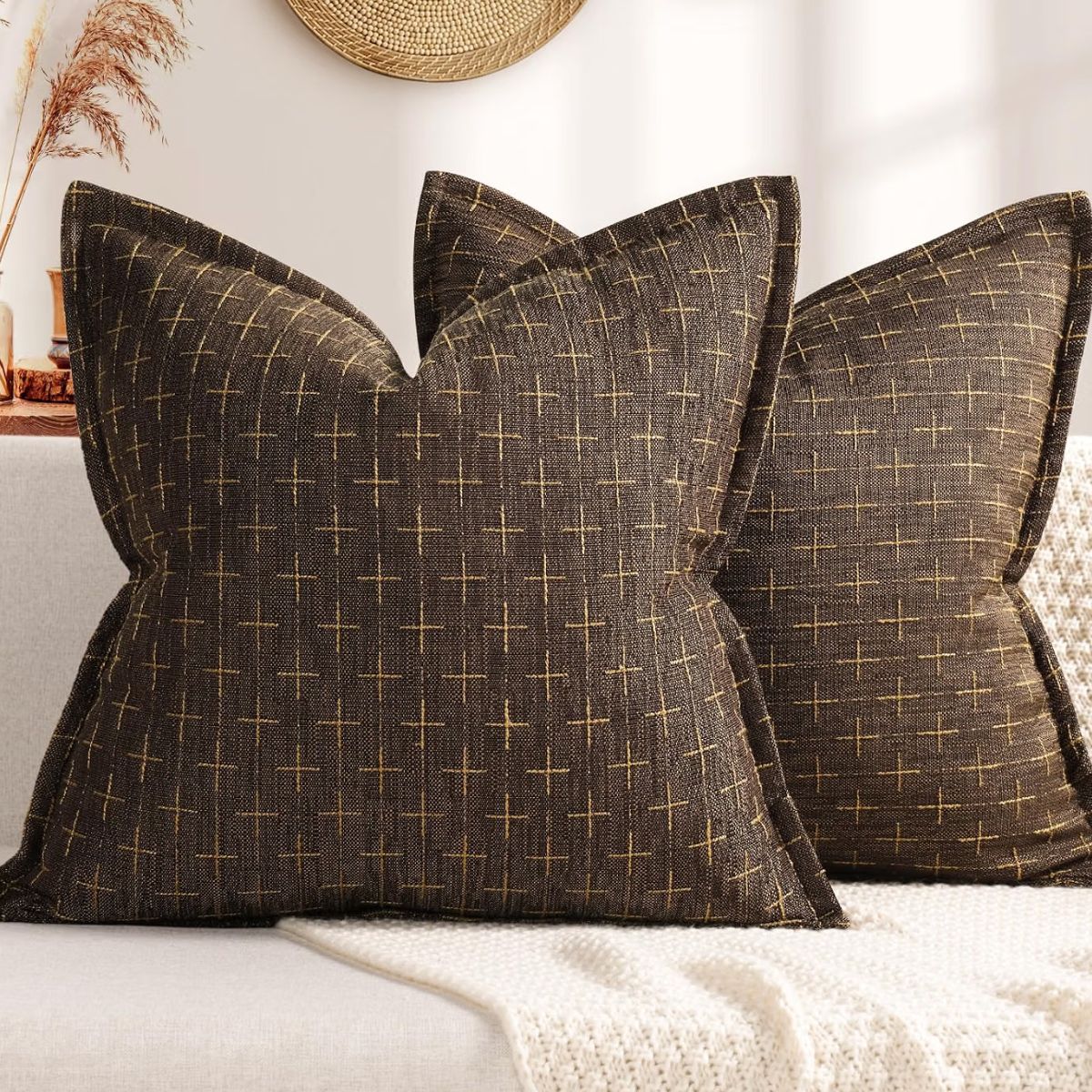 Dark brown farmhouse throw pillows with a subtle tan crosshatch pattern arranged on a neutral sofa.