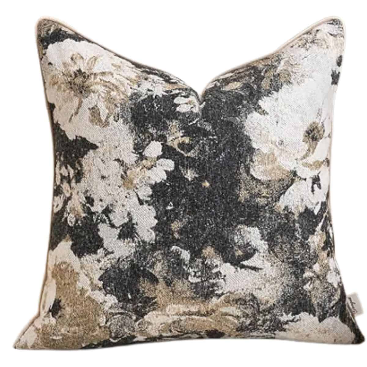 Neutral floral throw pillow with a black, cream, and beige vintage-inspired flower pattern.