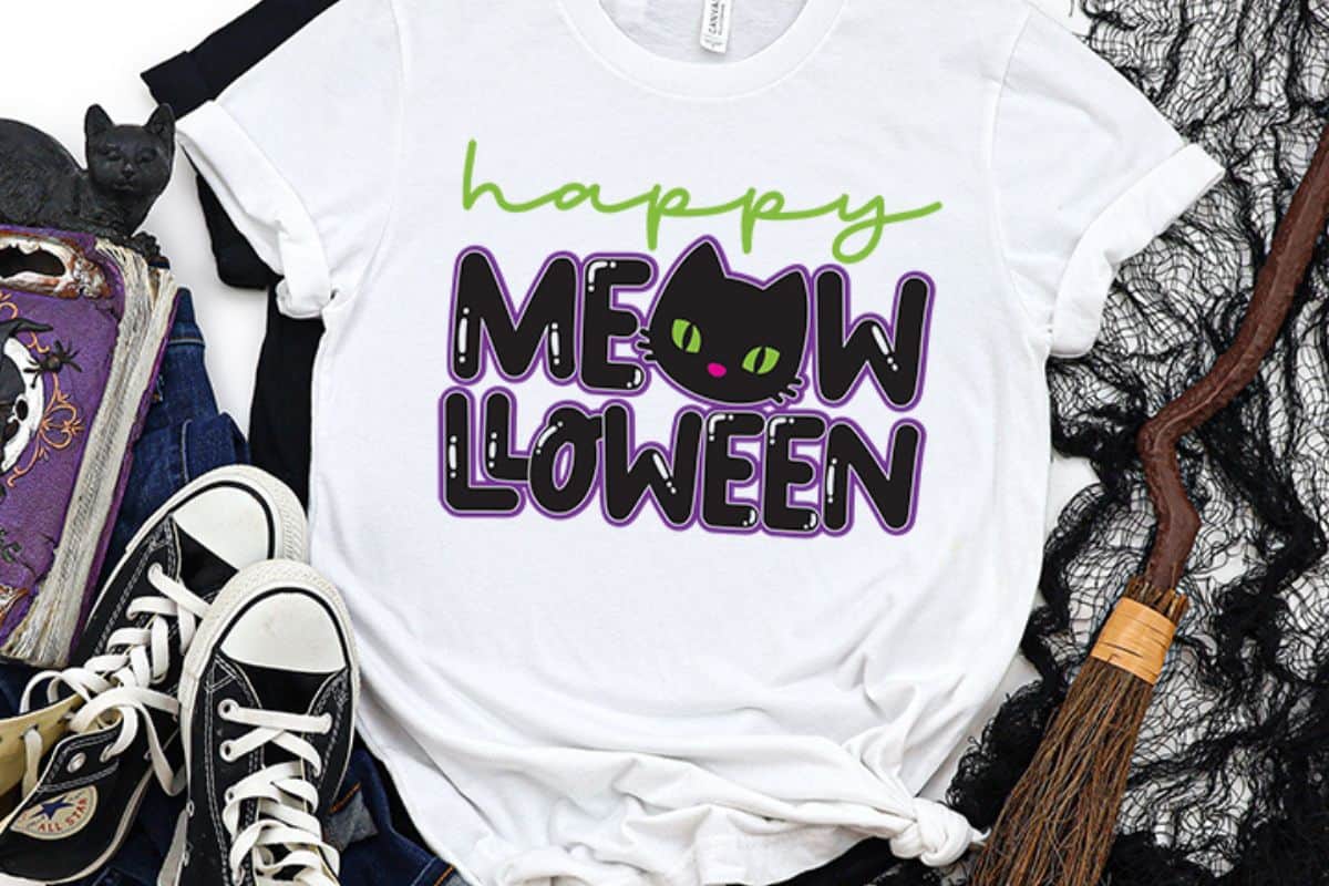 A white t-shirt with a design that reads 'Happy Meow-lloween'.