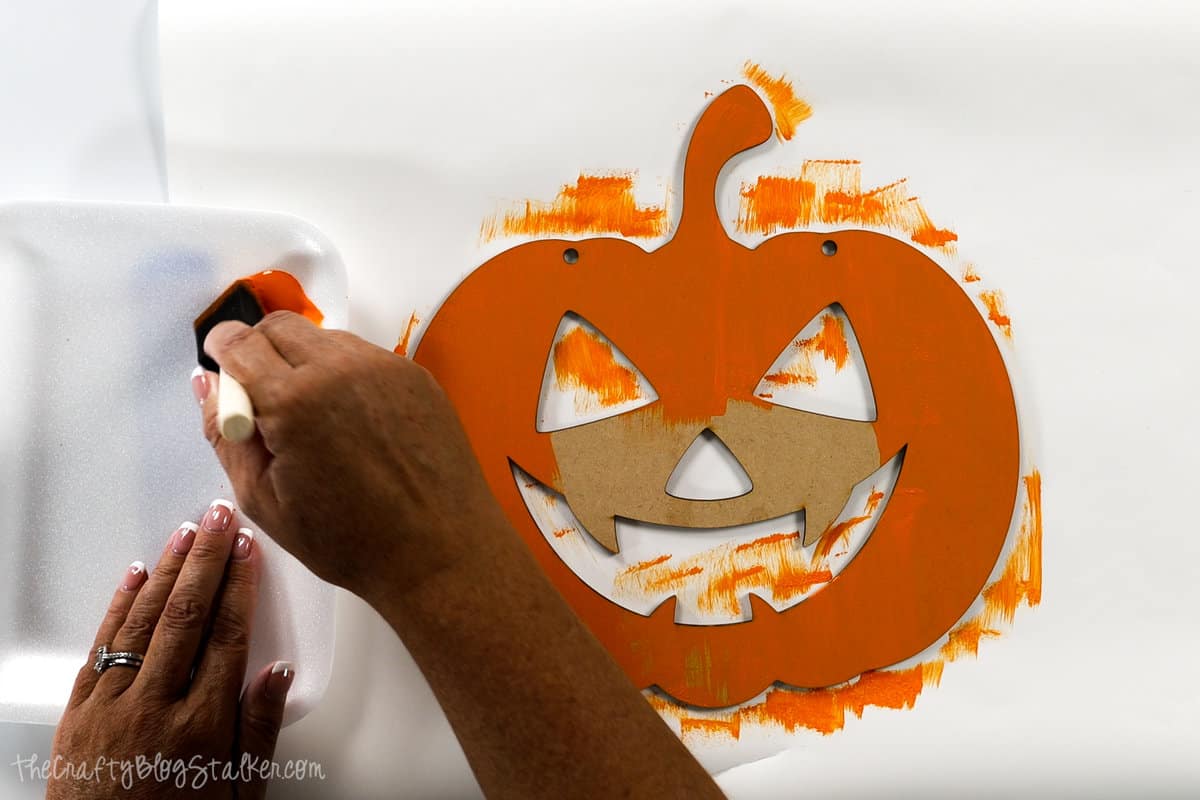 painting the pumpkin face orange