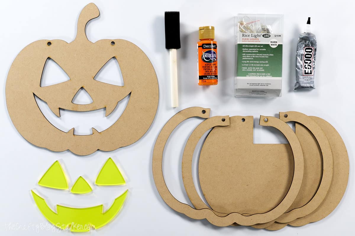 supplies used to make a Light up pumpkin door hanger