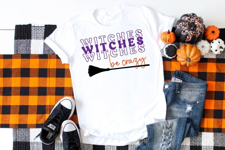 White t-shirt with a design on the front that reads 'Witches Be Crazy'.