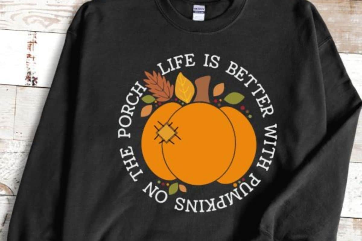 Life is Better with Pumpkins on the Porch SVG on a black sweatshirt.