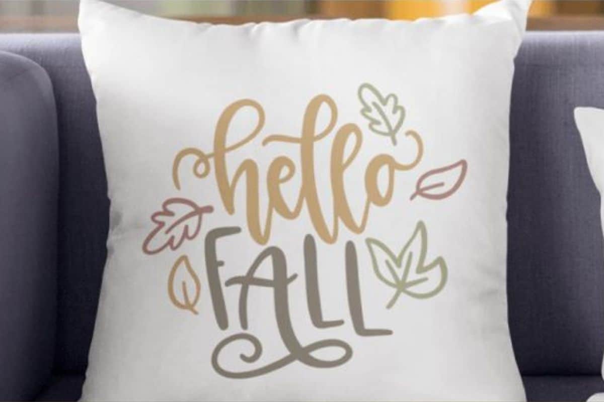 Throw pillow with a design that reads 'Hello Fall'.