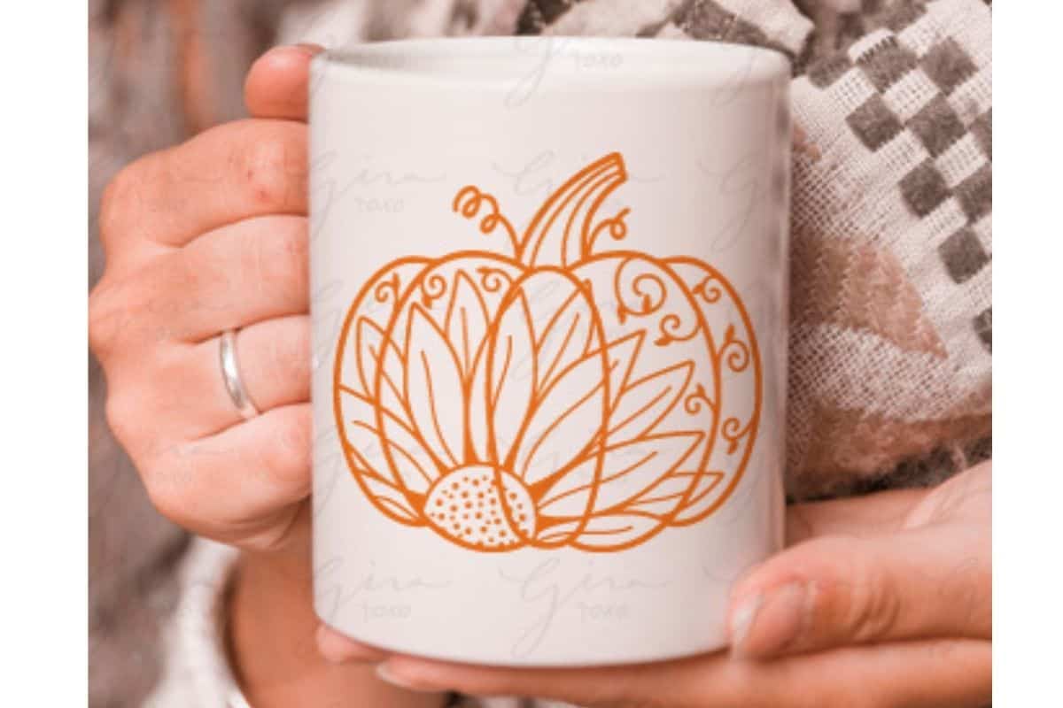 A mug with a sunflower pumpkin mandala design.