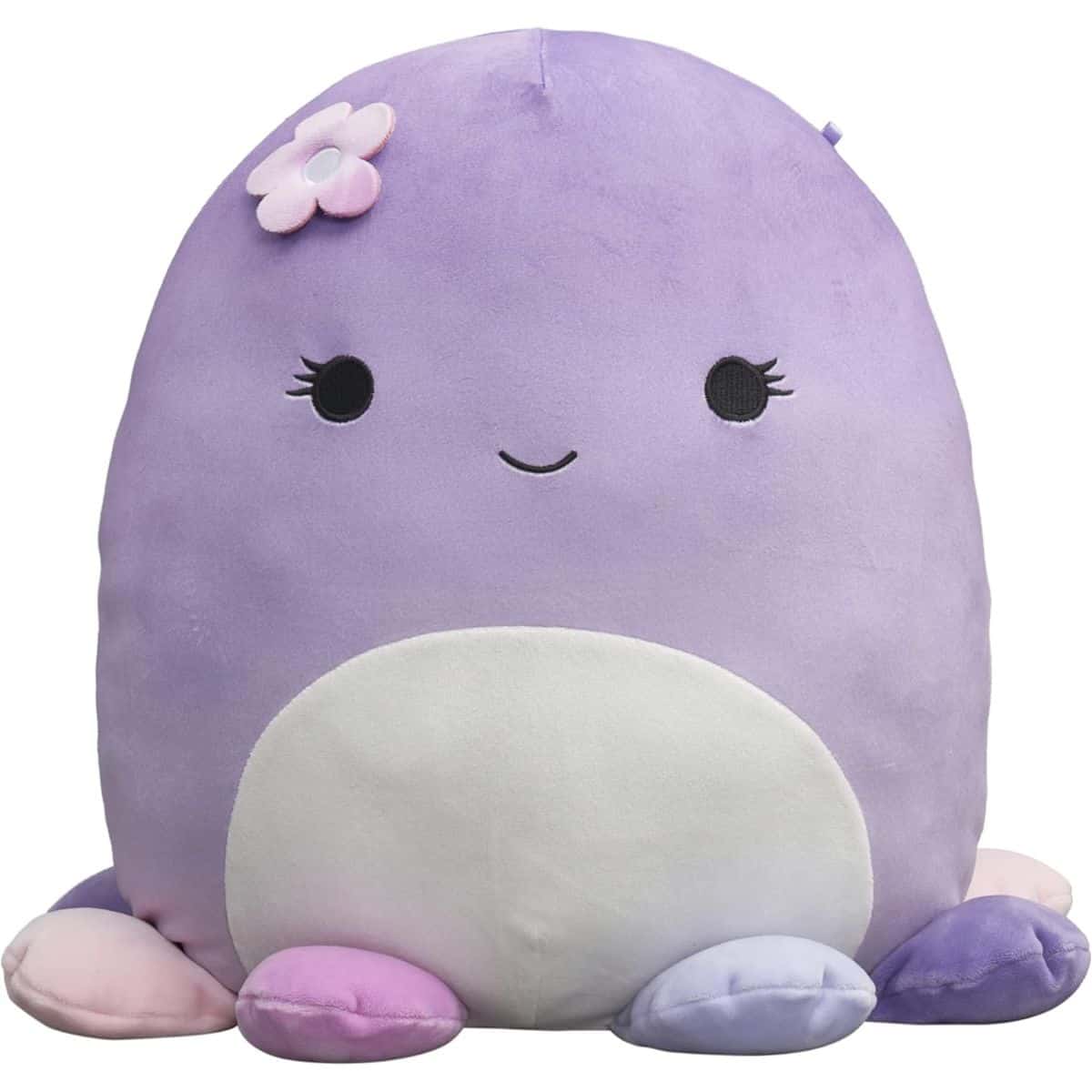 A large purple Squishmallow plush with a white belly, pastel feet, stitched facial features, and a pink flower accent on its head.
