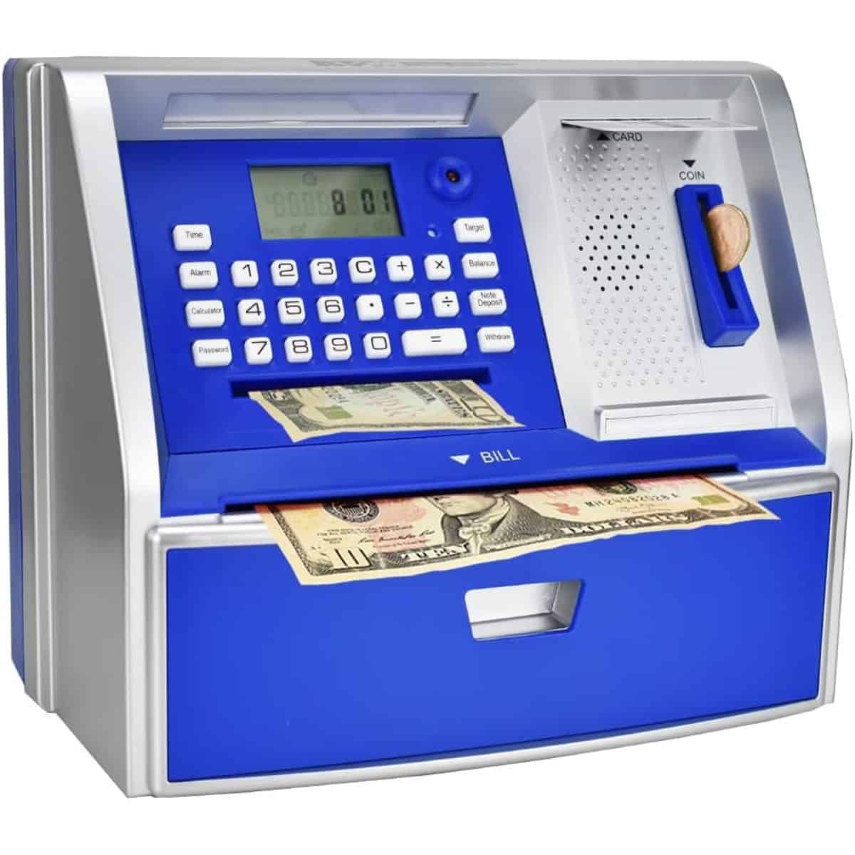 A kids' electronic ATM-style savings bank with a keypad, coin slot, bill feeder, and display screen, shown holding paper money as it deposits into the drawer.