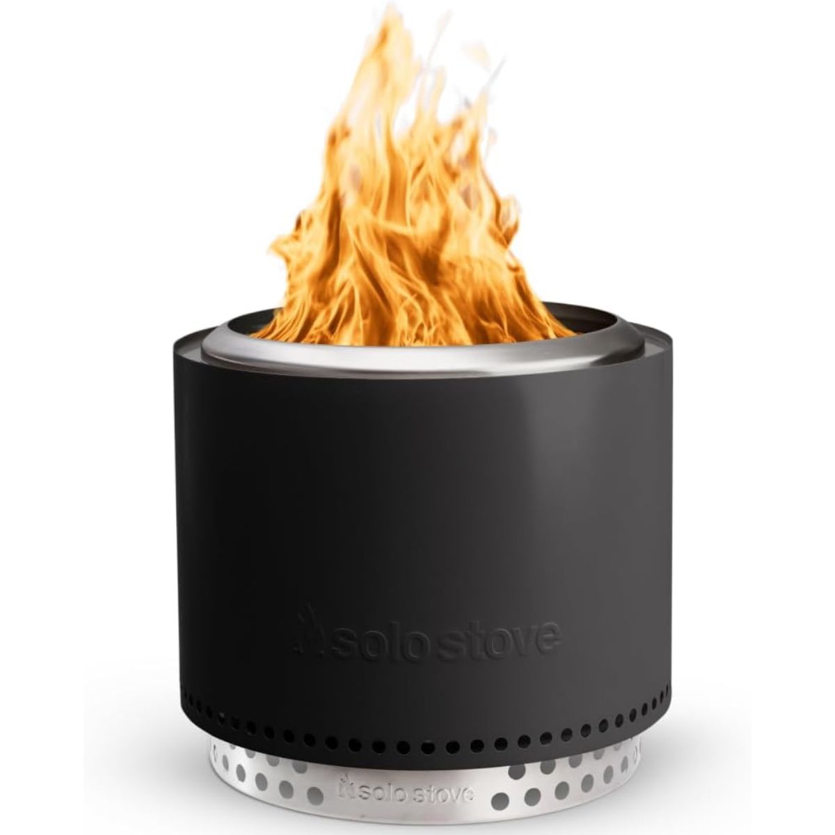 Modern black Solo Stove fire pit with bright flames rising from the top.