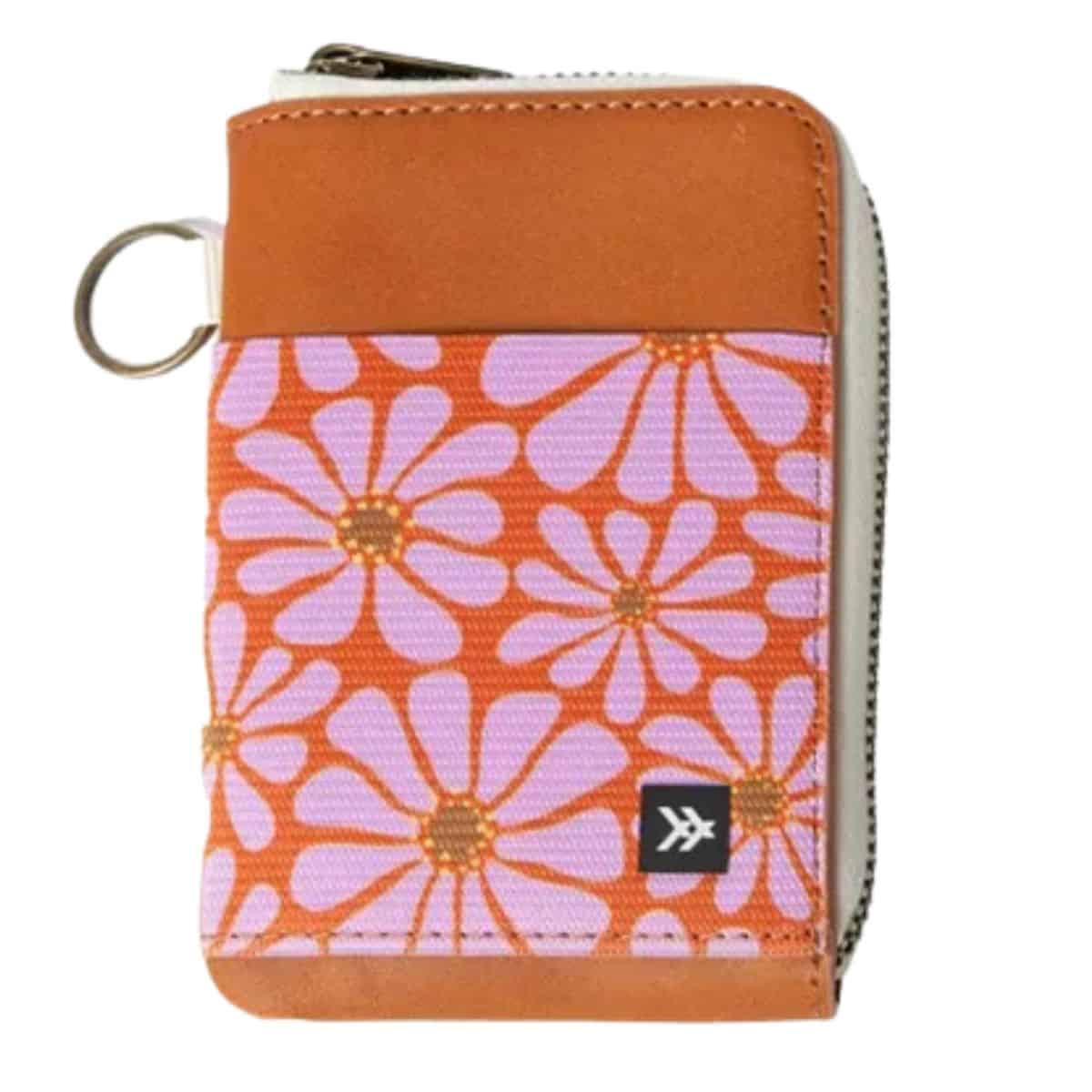 Colorful zipper wallet with orange and pink floral design, tan leather trim, and a small metal keyring on the corner.