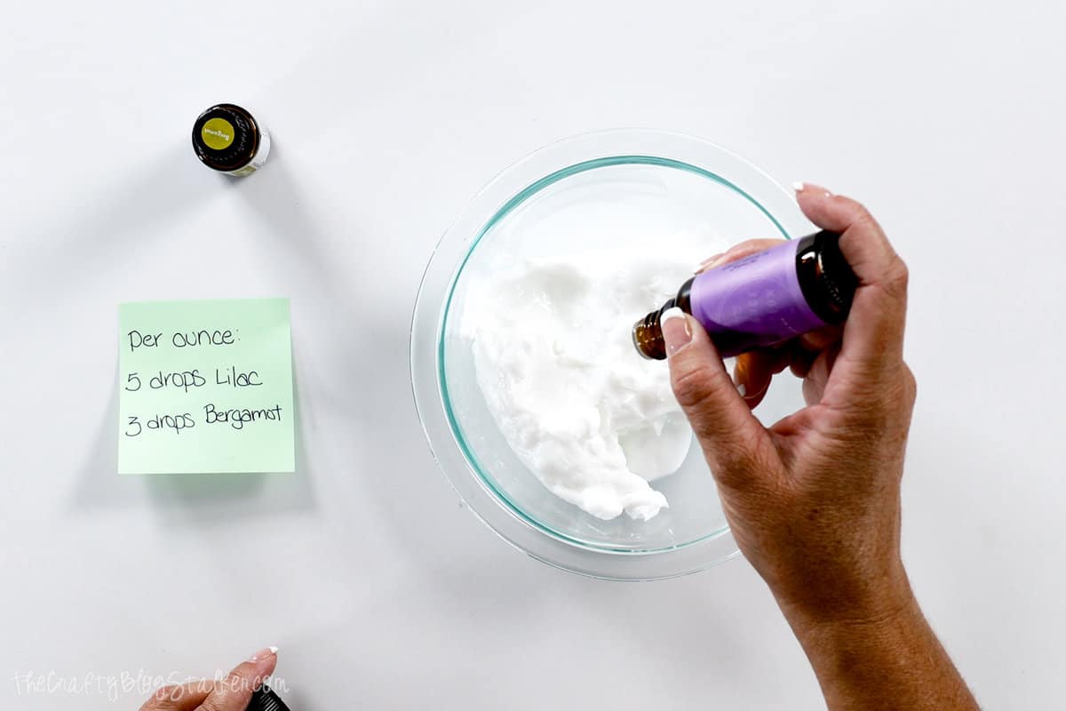 Adding lilac oil to lotion base.