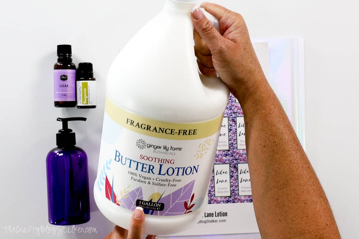 Supplies used to make lilac lotion, and hands holding a gallon jug of lotion base.