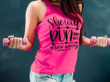 A woman wearing a pink tank top with the design She Will Run and Not Grow Weary.