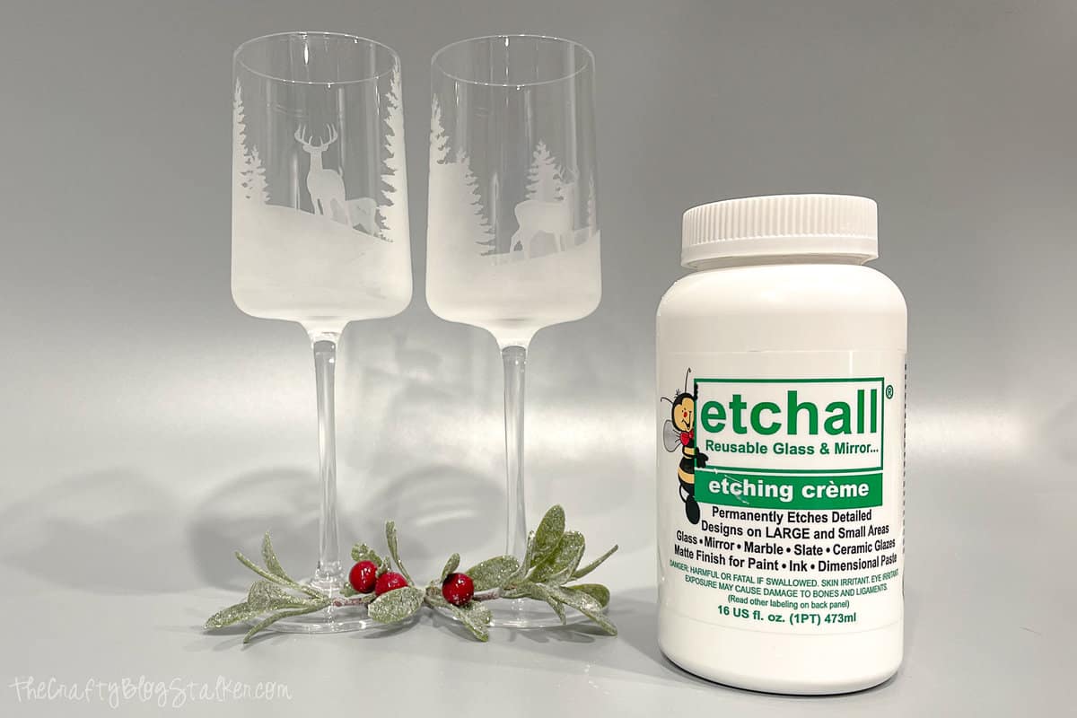 Two glass etched wine glasses with a bottle of Etchall.