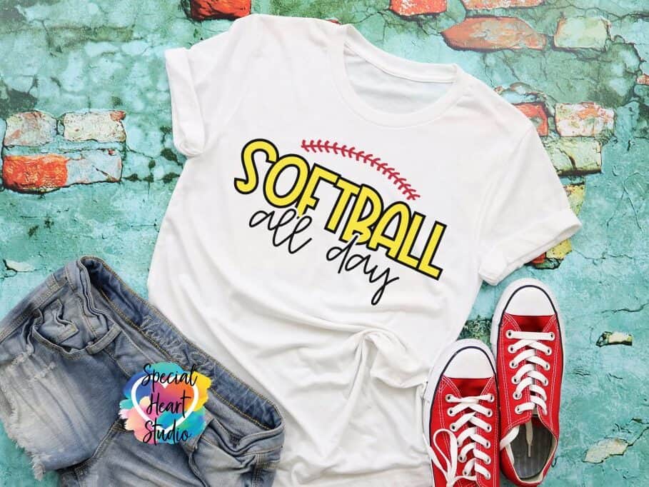 A T-shirt with a design that reads softball all day.