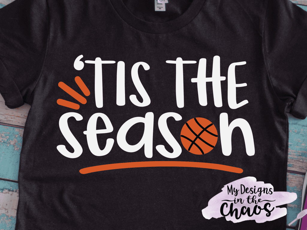 A T-shirt with a design that reads 'tis the season with a basketball.