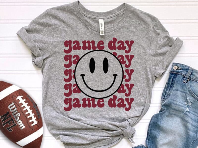 A T-shirt with a design that reads game day with a smiley face.