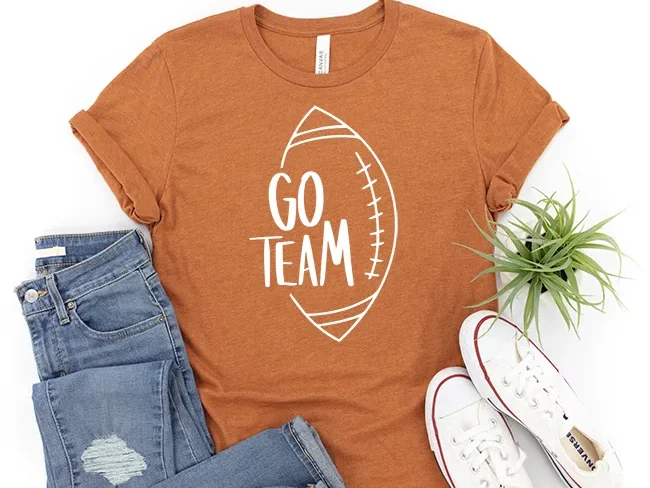 A T-shirt with a design that reads go team with a football.