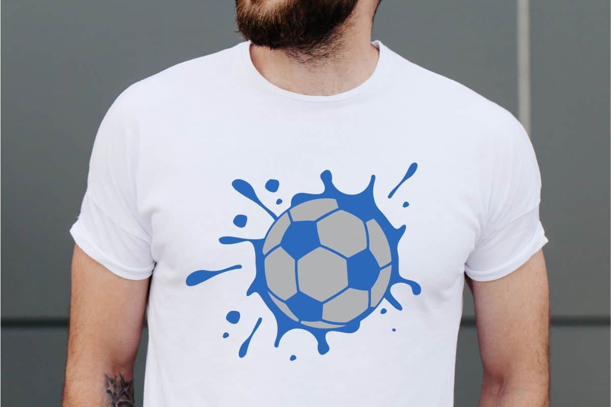 Man wearing a white t-shirt with a soccer splat design.