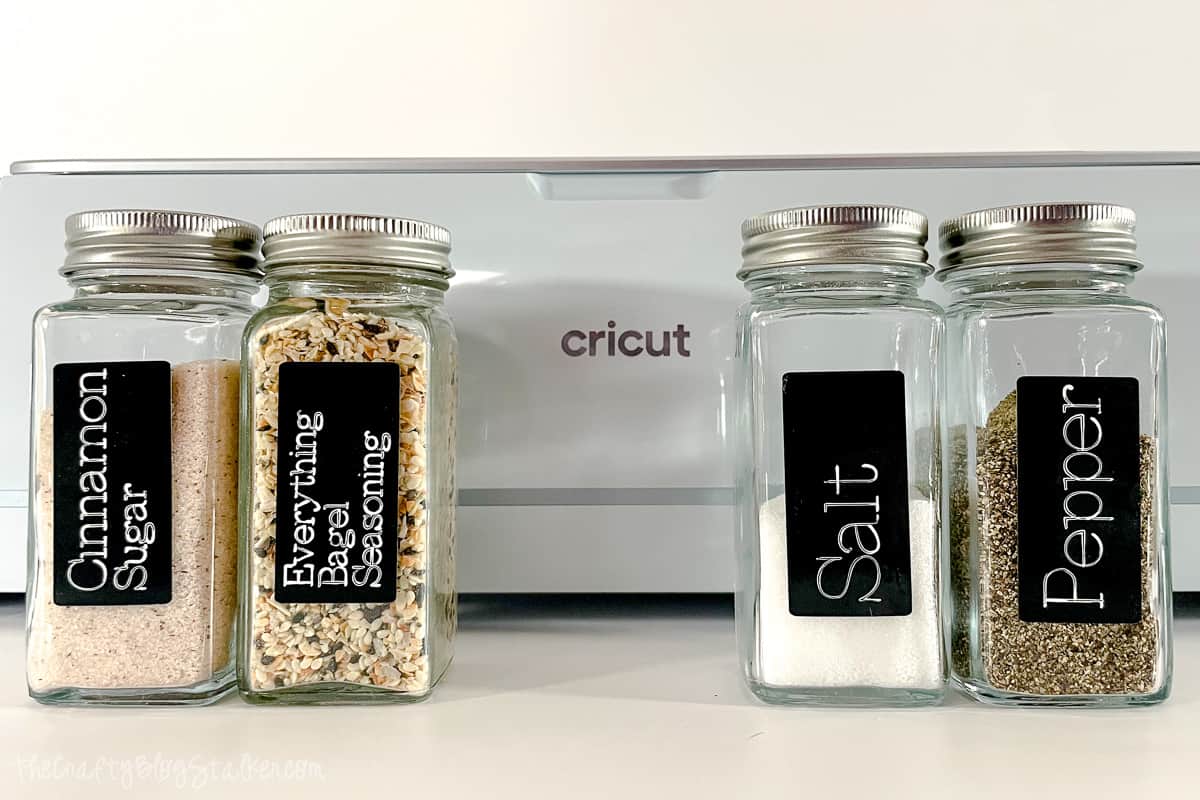 4 spice jars in front of a Cricut Maker.