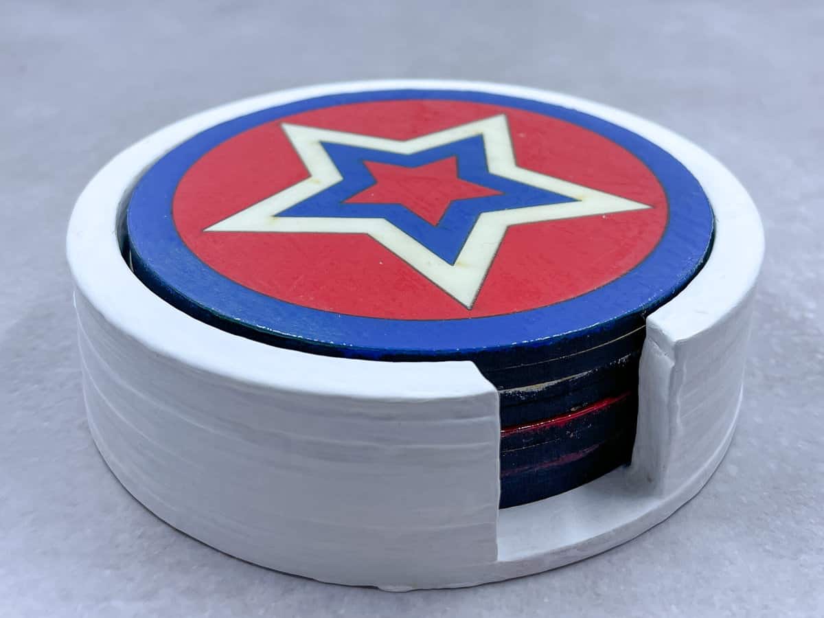 A set of star coasters in a coaster holder.