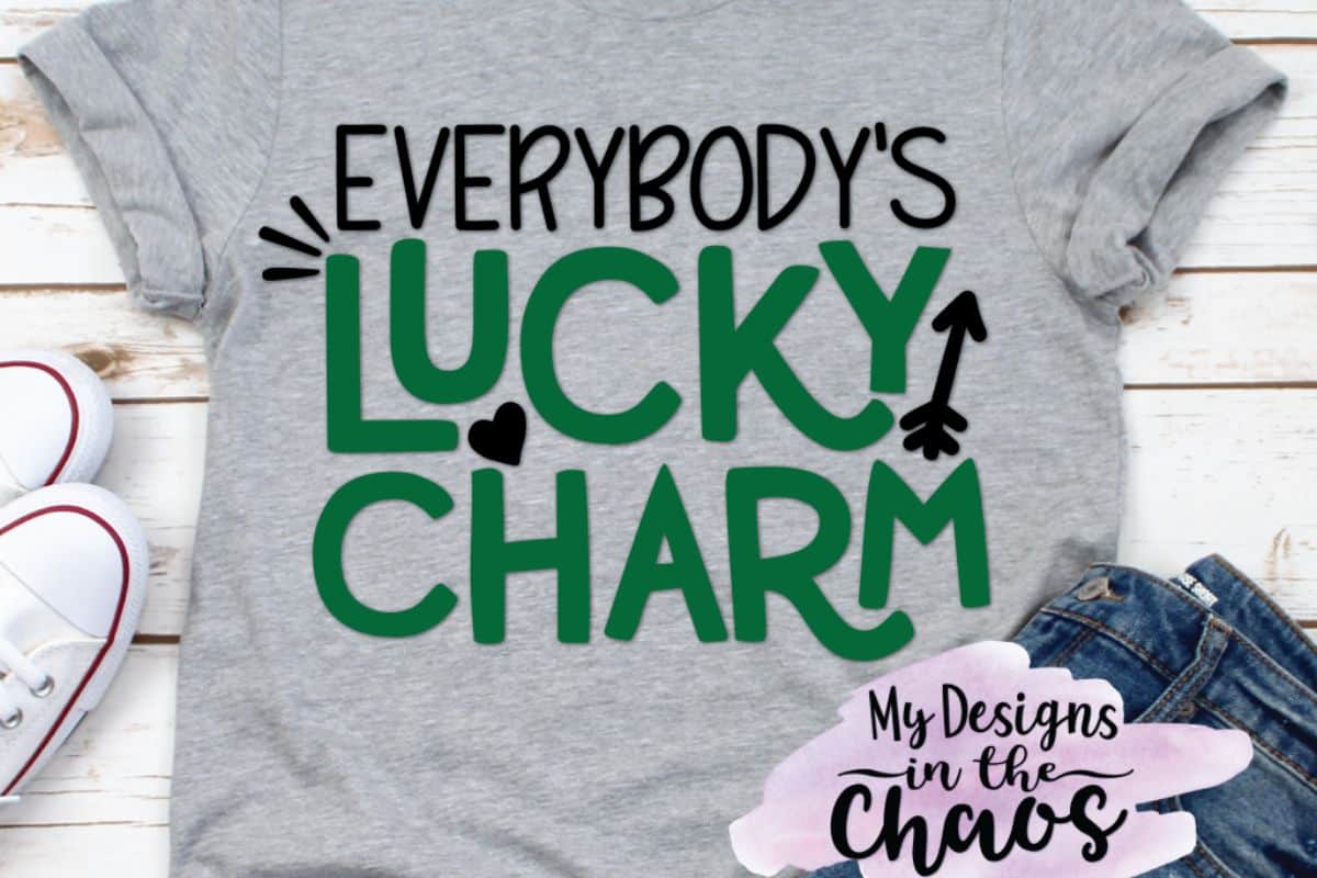 A gray shirt with a design that reads everybodys lucky charm.