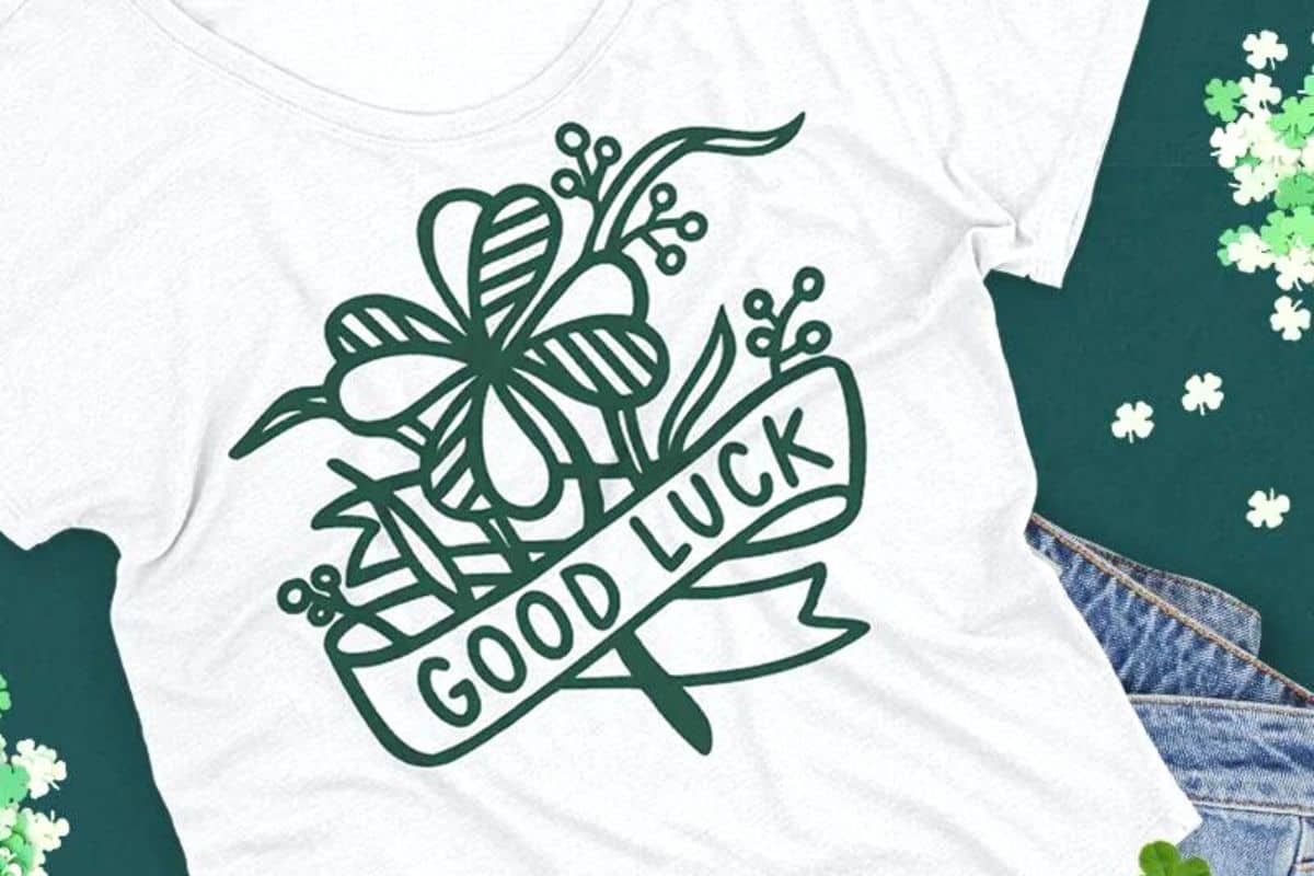 A white shirt with a design that reads good luck.