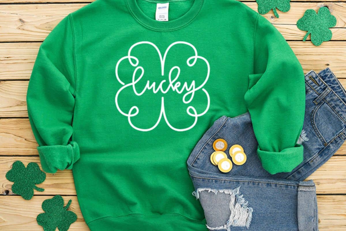 A green shirt with a design that reads lucky.