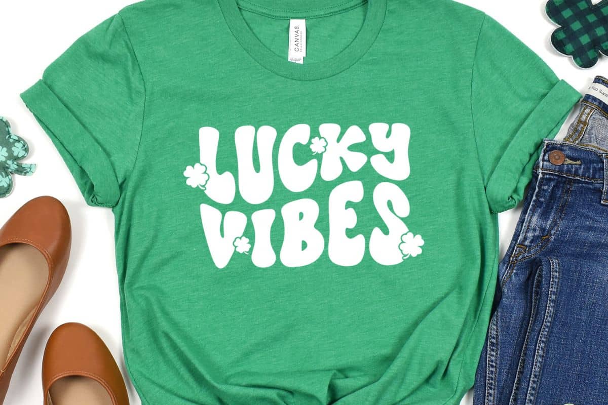 A green shirt with a design that reads lucky vibes.