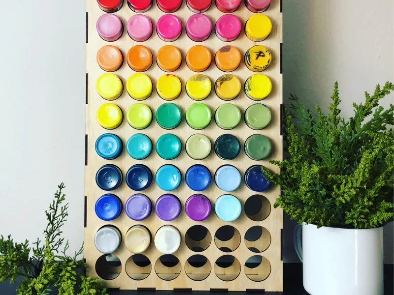 An acrylic paint organizer made from wood.