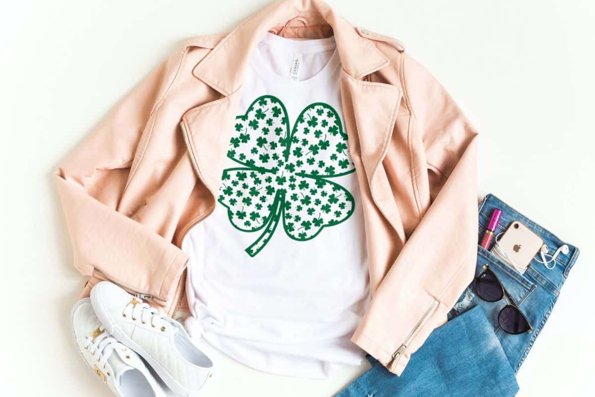 A white shirt with a green design of a clover.