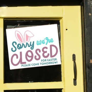 Closed for Easter printable sign hung on a yellow business door.