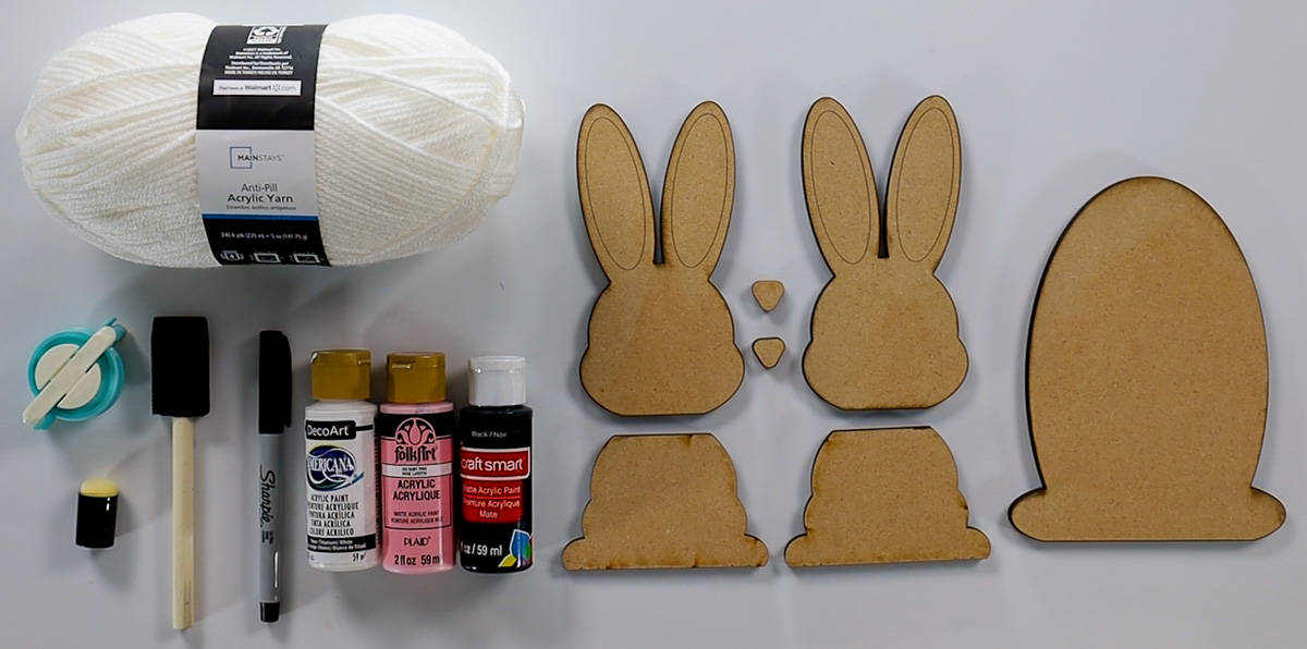 Supplies used: white yarn, paint, pom pom maker, foam paint brush, sharpie marker, and cut bunny pieces.