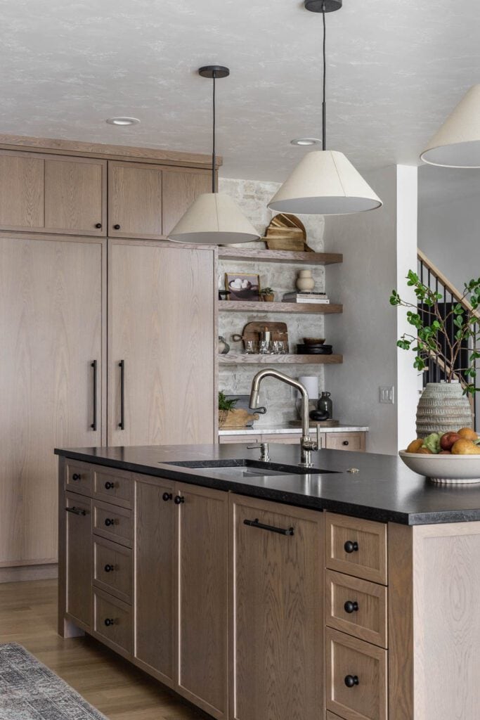 European-inspired kitchen with white oak cabinets and open shelving.