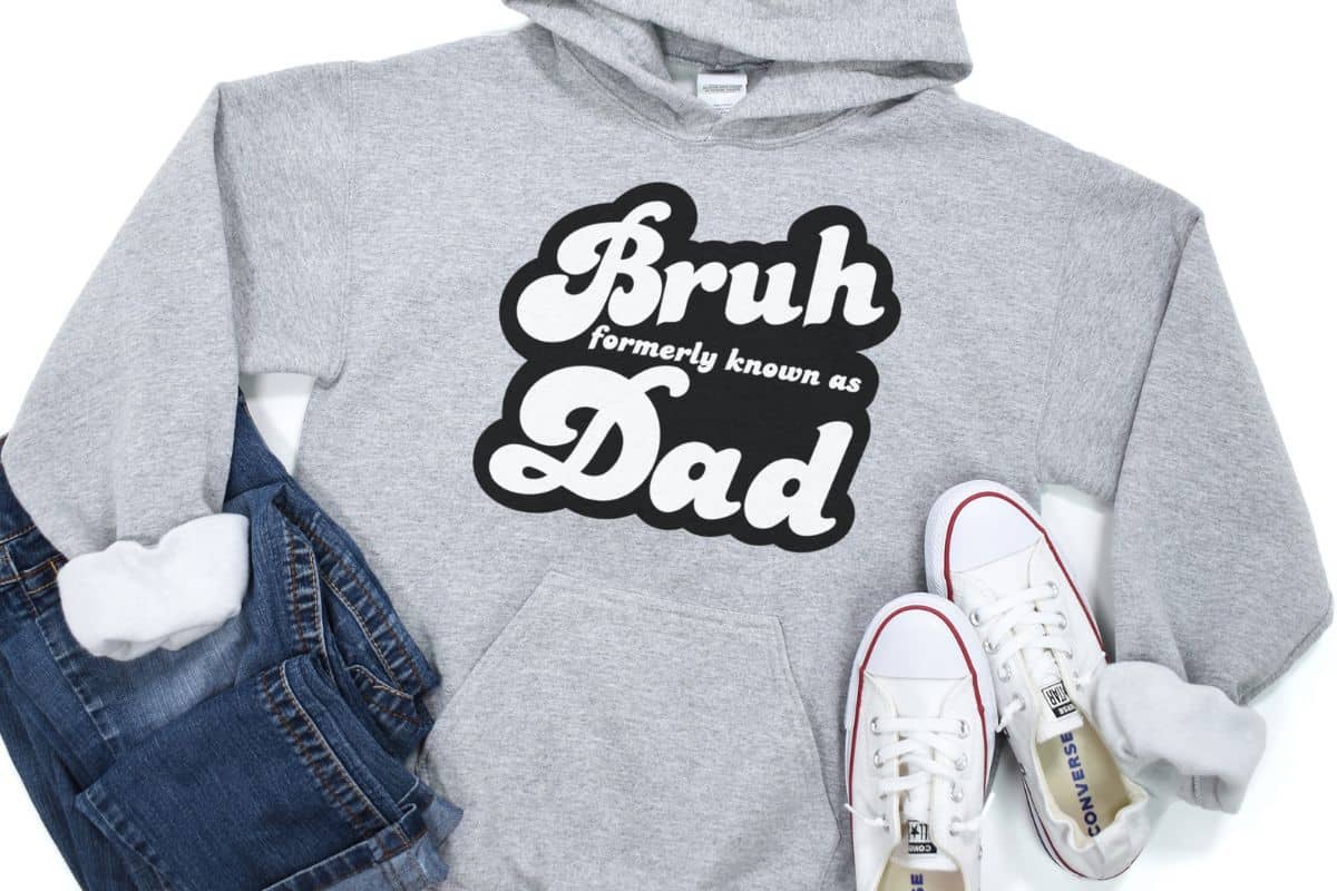 Flay lay with a gray sweatshirt and a design that reads "Bruh formerly known as Dad".
