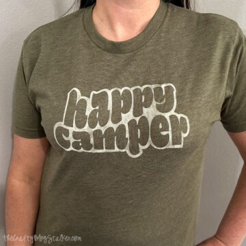 Woman wearing a shirt that reads 'happy camper'.