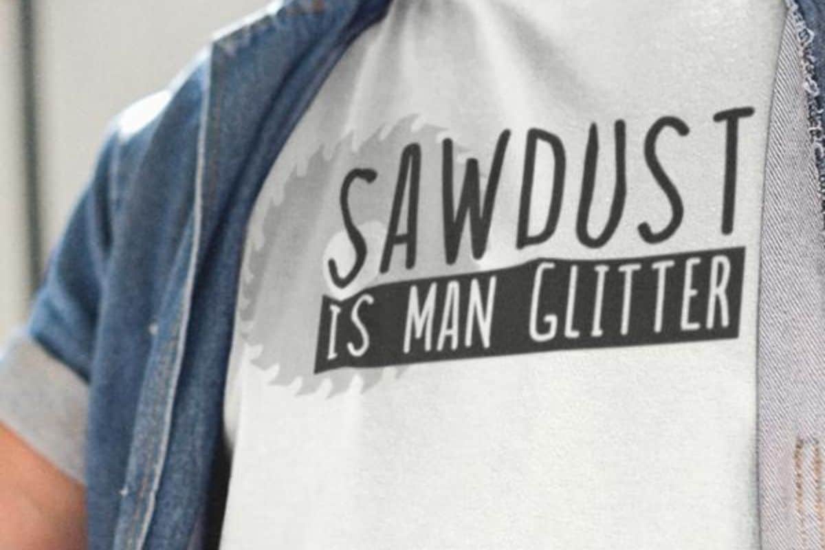 Am an wearing a white t-shirt with a design that reads "sawdust is man glitter".