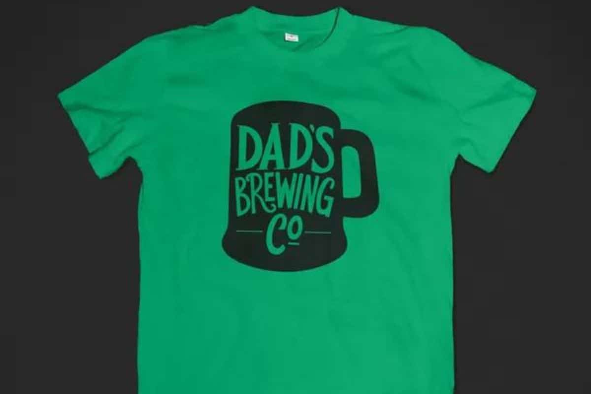 A green t-shirt with a design that reads "Dad's breweing Co".