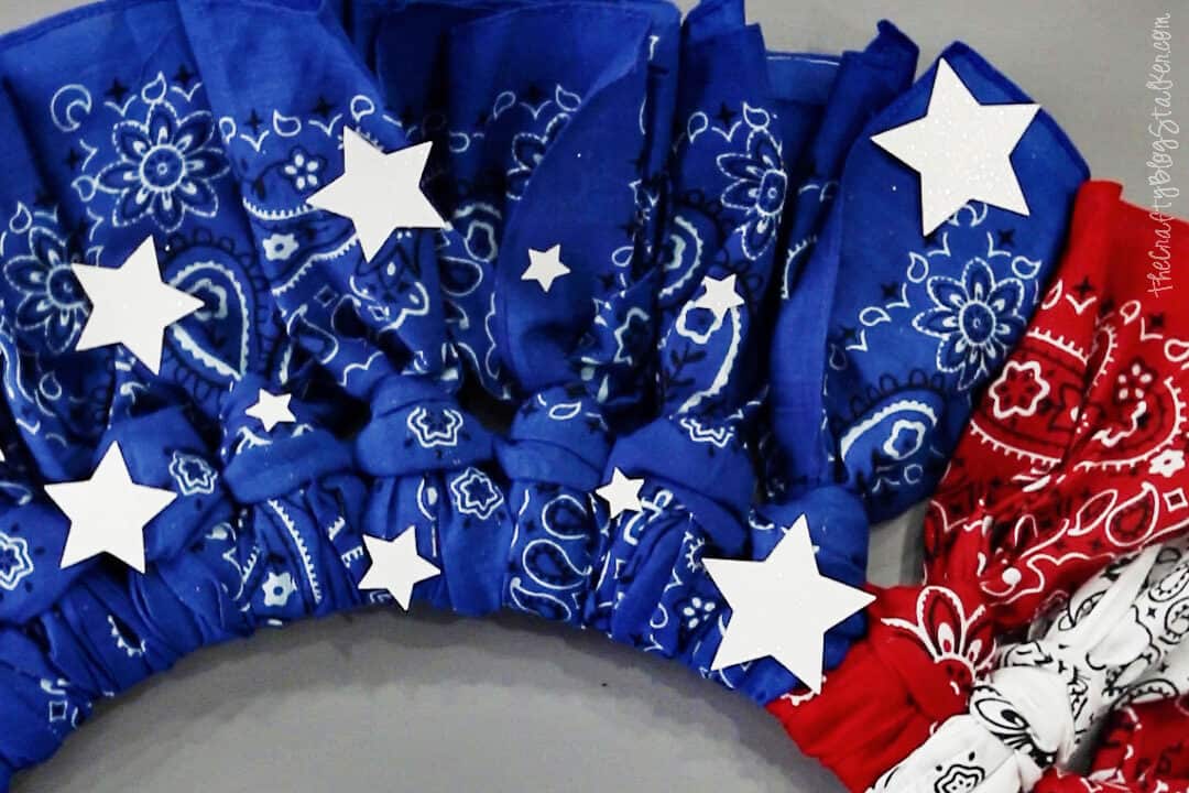 White glitter stars on a patriotic wreath.