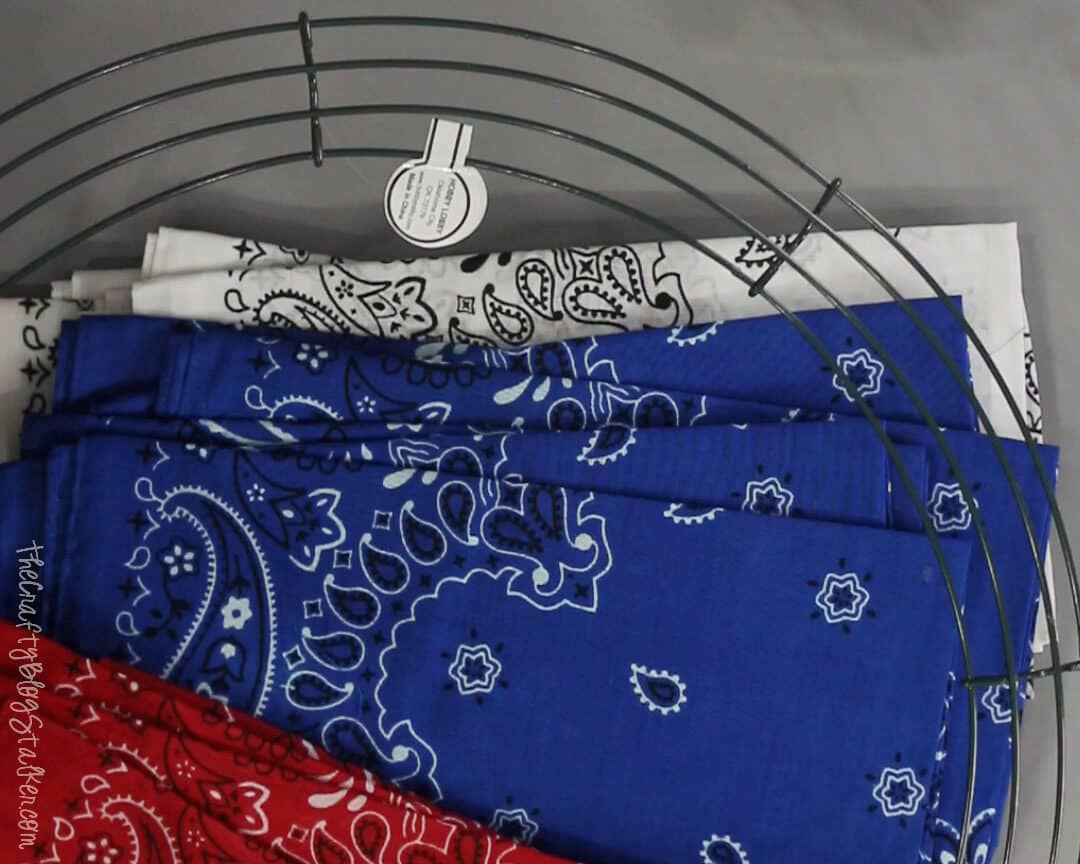 A 16-inch wire wreath form and red, white, and blue bandanas to make a patriotic wreath.