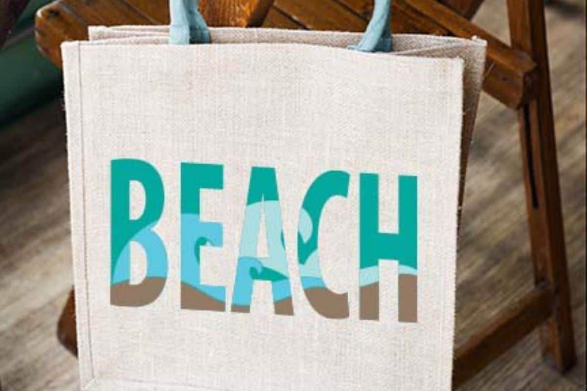 Beach SVG cut file on a tote bag.