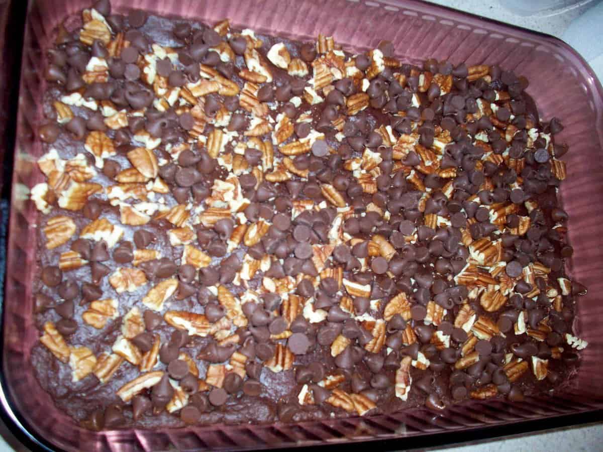 nuts and chocolate layered on the brownies