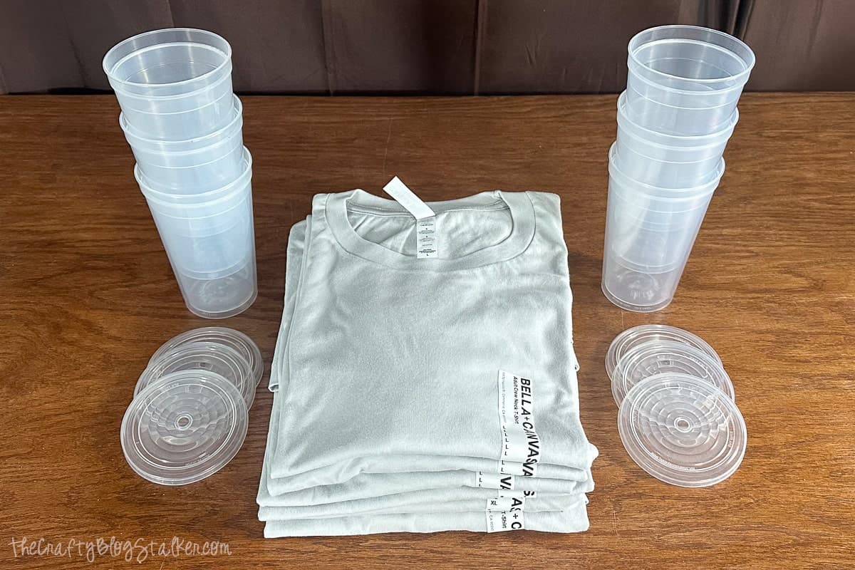 6 folded t-shirts and 6 plastics cups with lids.