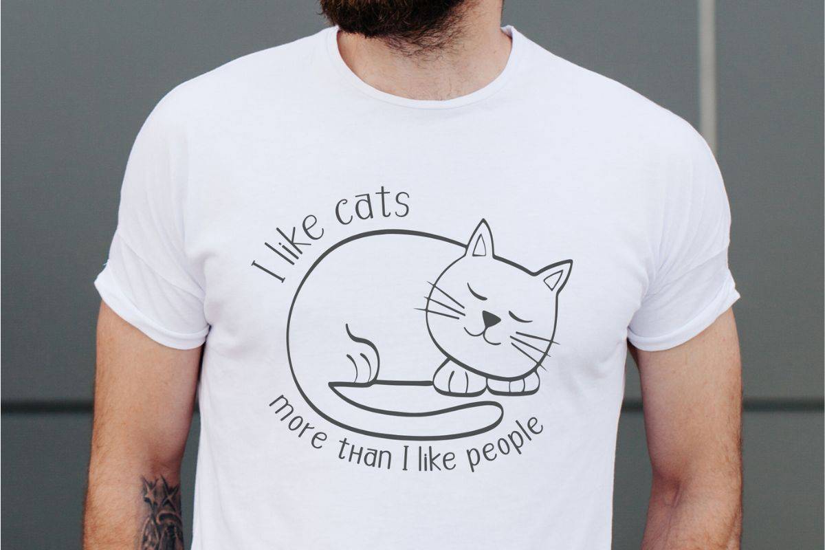 Man wearing at-shirt with a design that reads I like cats more than I like people.