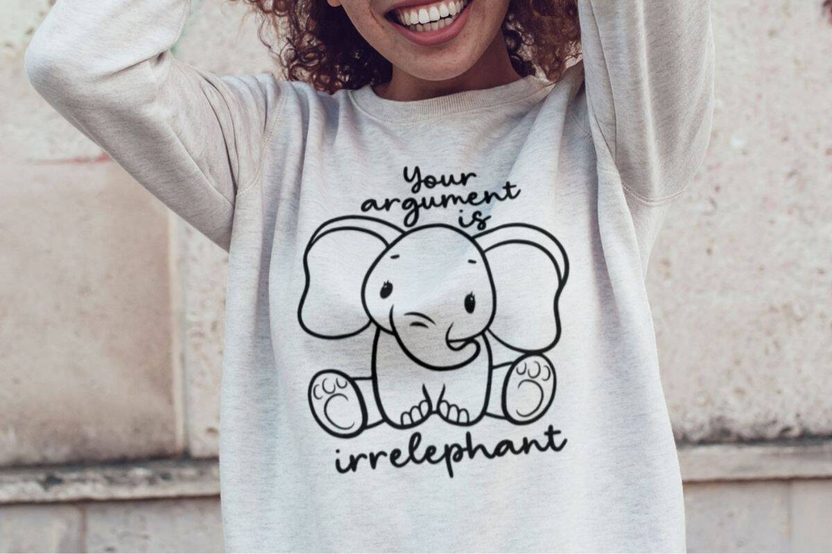 A woman wearing a sweatshirt with an elephant design that reads Your Argument is Irrelephant.
