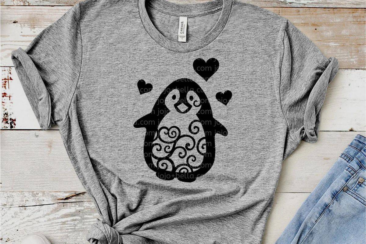 A gray t-shirt with a penguin design on the front.