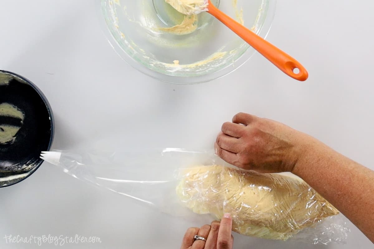 Placing tube of soap into a piping bag.