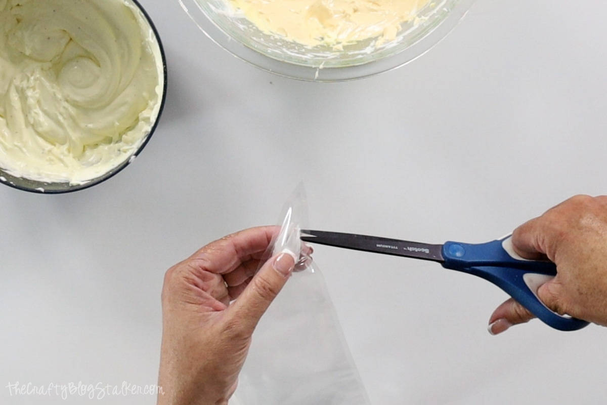 Placing a decorating tip in a piping bag.